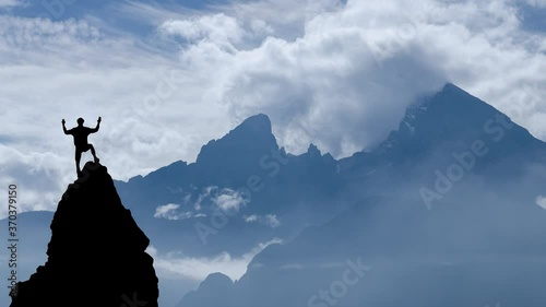 Male climber on a rock in front of mountain watzmann photo