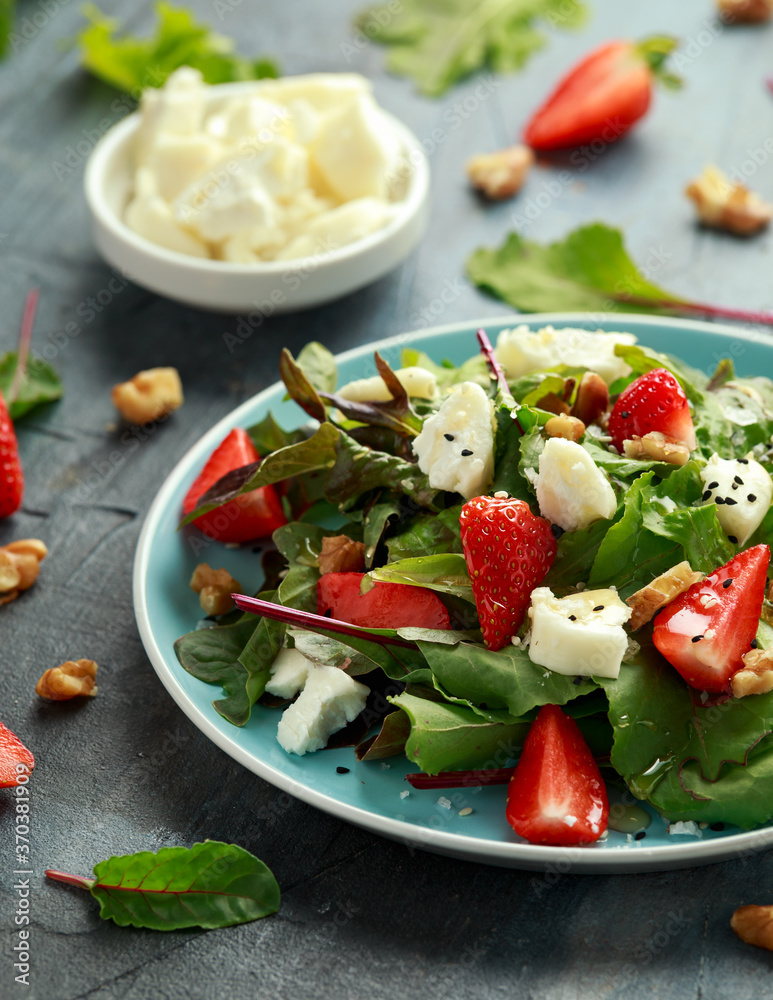 Goats cheese and strawberry summer salad served with nigella and sesame seeds drizzled with runny honey Goats cheese and strawberry summer salad served with nigella and sesame seeds drizzled with runny honey
