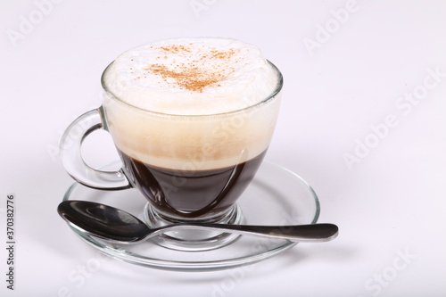 Delicious coffee in a glass cup on a white background