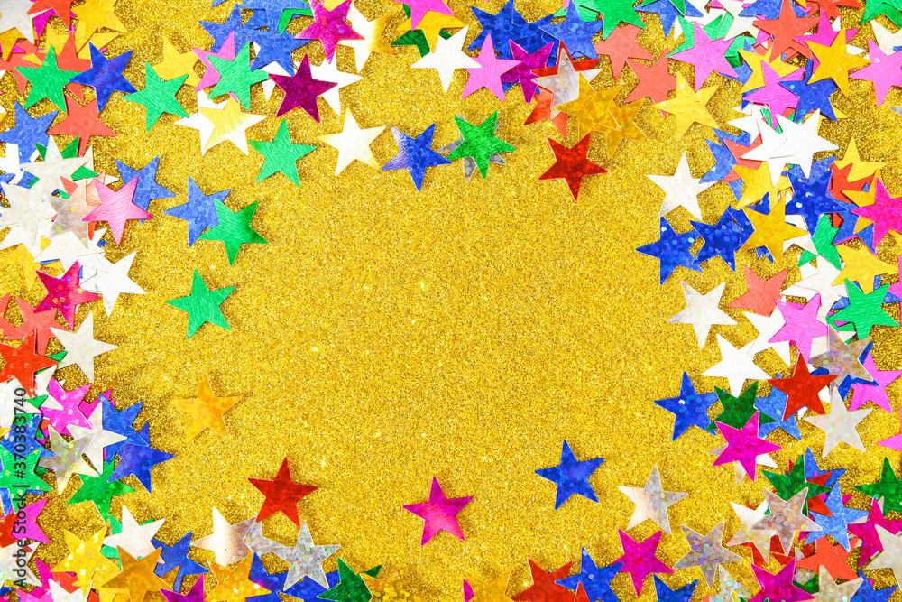 Background of multicolored stars on colored paper with sequins