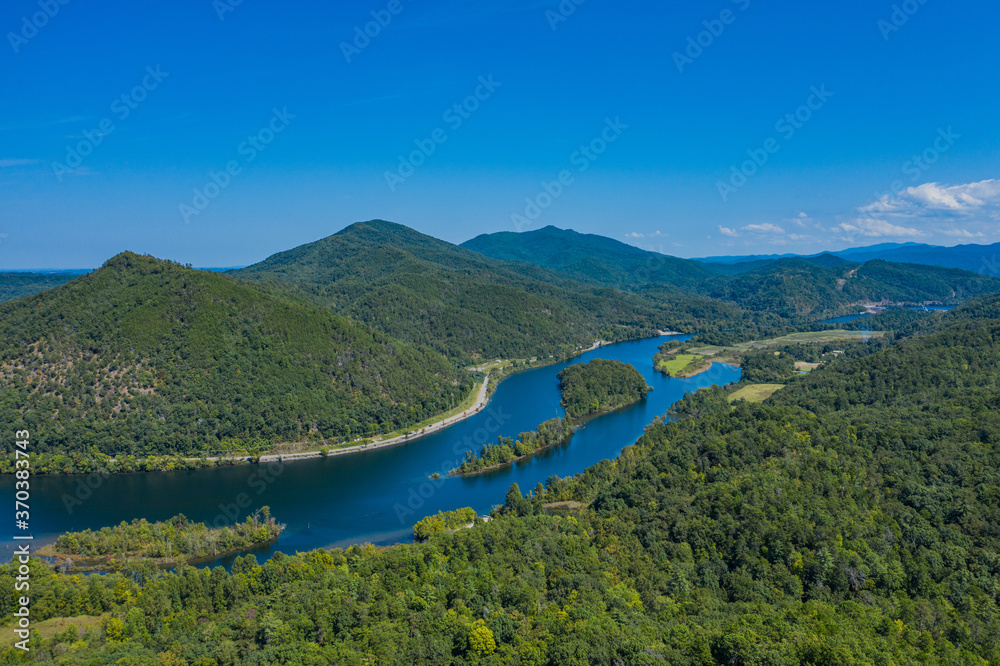 landscape with river, mountains, and blue sky
