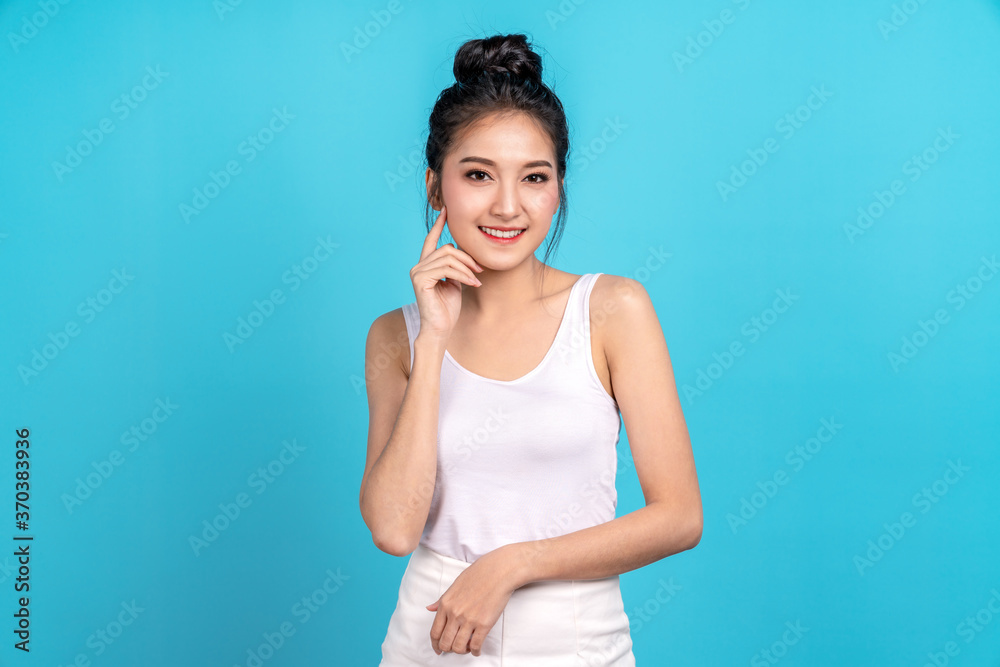Portrait headshot of beauty young asian woman face natural clean skin with cosmetology and spa. Studio shot on blue isolated background. Portrait headshot of beauty young asian woman face natural clean skin with cosmetology and spa. Studio shot on blue isolated background.