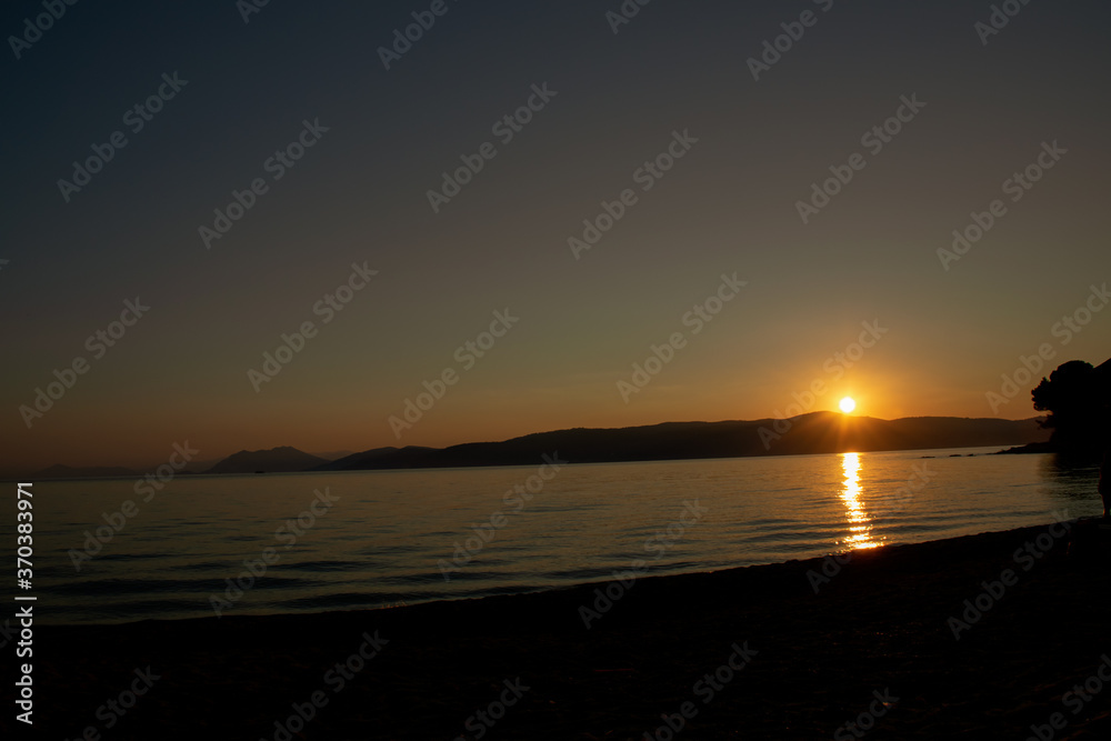 sunset over the sea, at Agia Eleni beach in Skiathos, Greece sunset over the sea, at Agia Eleni beach in Skiathos, Greece