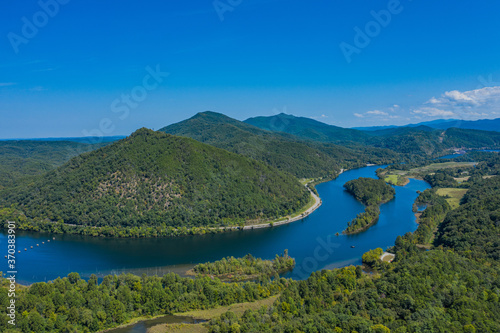 landscape with river, mountains, and blue sky © Joseph