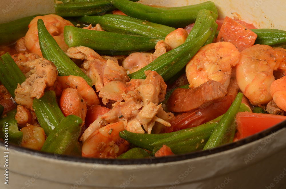 Fototapeta premium GUMBO INGREDIENTS, SHRIMPS, PORK SAUSAGE, CKICKEN, OKRA, GARLIC, TOMATOES, SPICES, GUMBO FILE