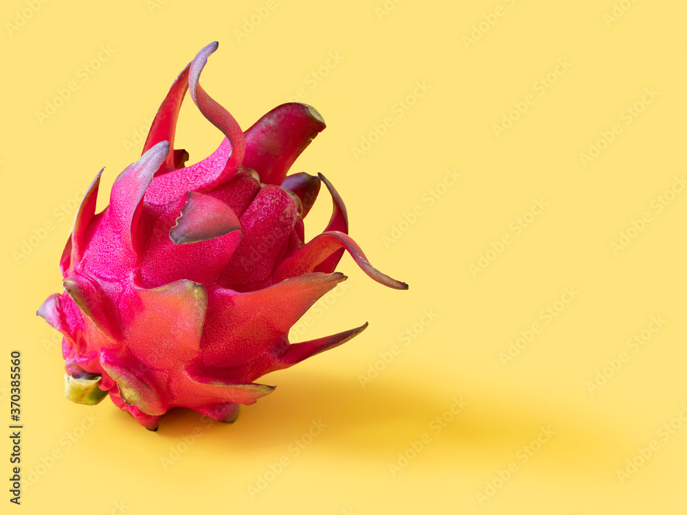 Pink pitahaya on a yellow background. Close up. Pink pitahaya on a yellow background. Close up.