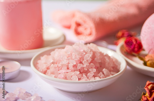 Pink bath salt and body care products with pink roses. Beauty treatment. Spa relax concept.