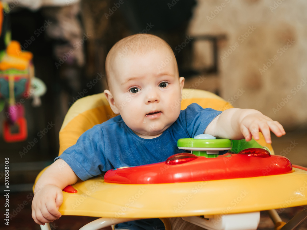 portrait of a cute Caucasian baby boy in a Walker portrait of a cute Caucasian baby boy in a Walker