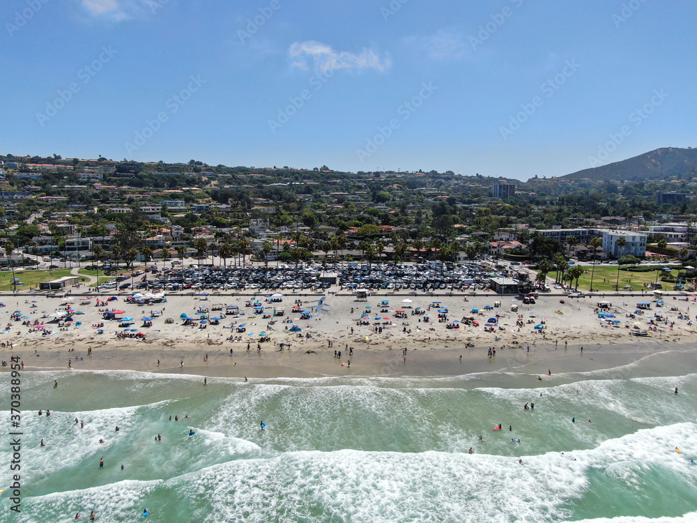 Aerial view of La Jolla bay with nice small waves and tourist enjoying the beach and summer day. La Jolla, San Diego, California, USA. Beach with pacific ocean