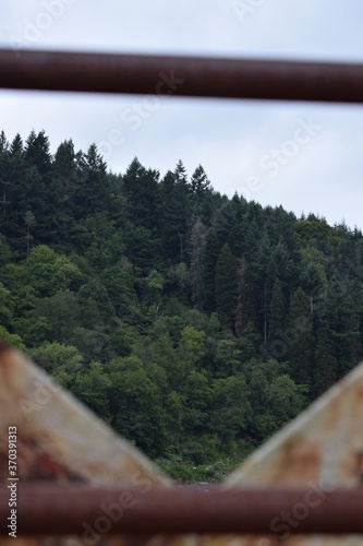 A view of the Green Countryside through a Bridge on a Cloudy Day