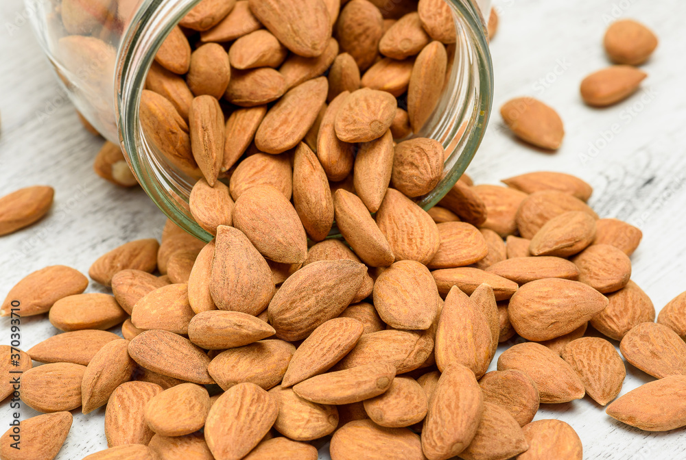 Almond nuts on the white rustic wooden background. Almond nuts on the white rustic wooden background.