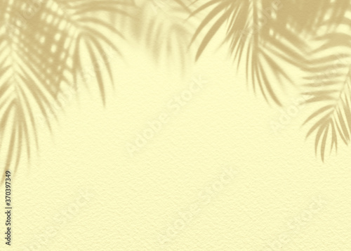 Yellow clay mud grunge cement texture wall leaf plant shadow background.Summer tropical travel beach with minimal concept. Flat lay palm nature.