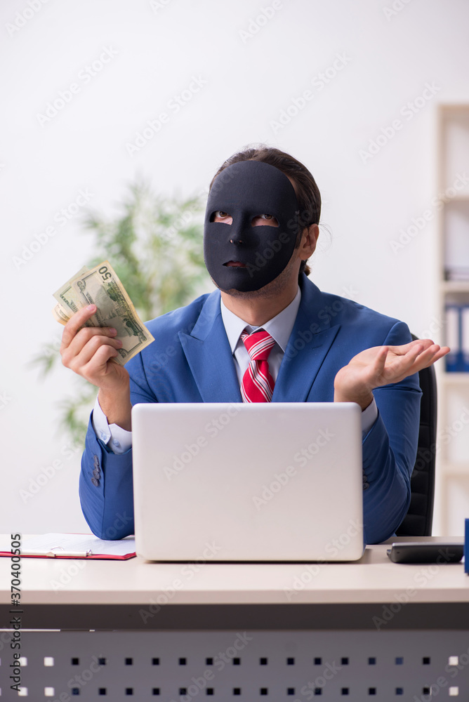 Male employee with mask in hipocrisy concept