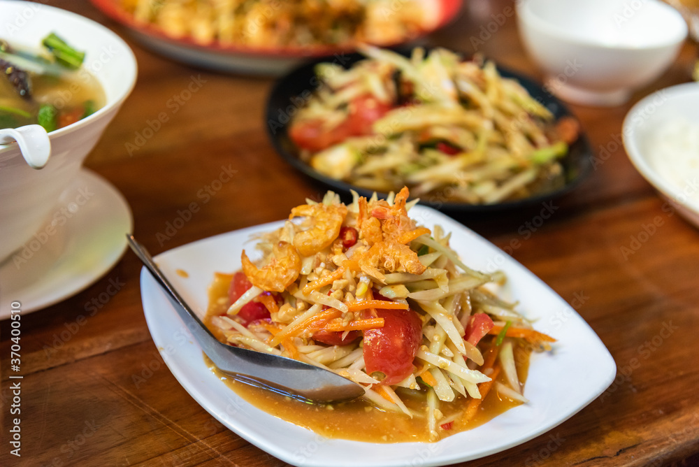 Som tam thai, spicy papaya salad with dried shrimp and nut. Som tam thai, spicy papaya salad with dried shrimp and nut.