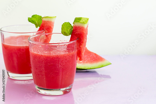 Watermelon pulp smoothie. Delicious red sliced watermelon on a plate. Stock of fiber and fructose. Summer food concept.