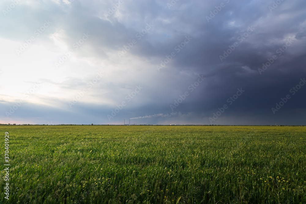 overcast clouds over a green field / landscape before a thunderstorm