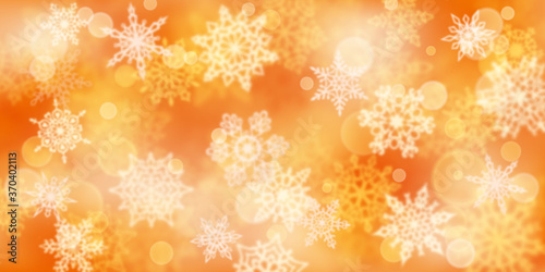 Christmas background of blurry snowflakes in yellow colors