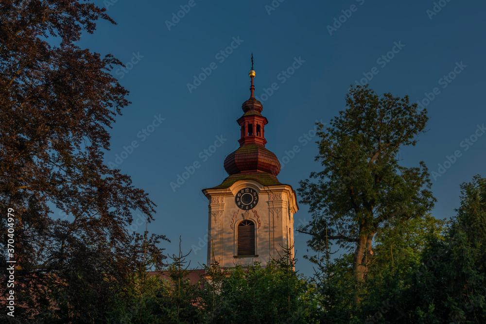 Church and castle in Petrovice village in central Bohemia in summer evening