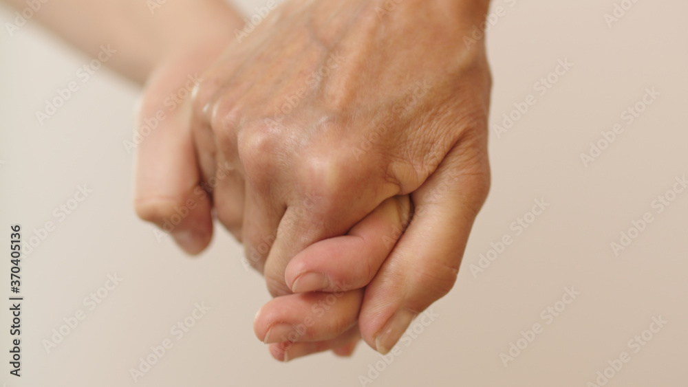 Fototapeta premium Old and young hand holding together. Close up shot. High quality photo