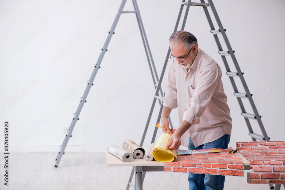 Old husband contractor in home renovation concept Old husband contractor in home renovation concept