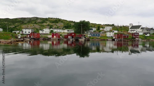 SALVAGE, NEWFOUNDLAND AND LABRADOR, CANADA – JULY 10, 2020.Traditional fishing community with red sheds and boats, taken on July 10, 2020 in Salvage.  photo