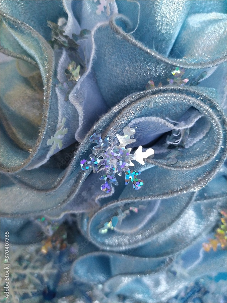 Fototapeta premium Beautiful blue shiny background for a christmas card with white beads and snowflakes