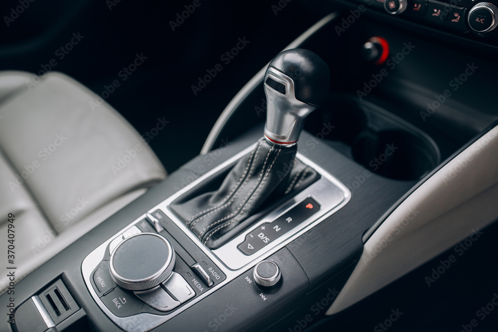 Modern and expensive car interior and gearbox shift handle 