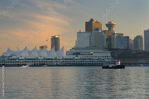 Downtown Vancouver and Canada Place at dusk with tugboat and seaplanes © Reimar