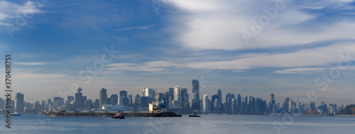 Panorama of Vancouver skyline with coal cargo ship tugboats and Seabus in Burrard Inlet © Reimar