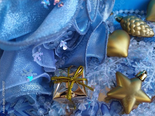 Beautiful blue background for a christmas card with gilged gold toys on the christmas tree photo