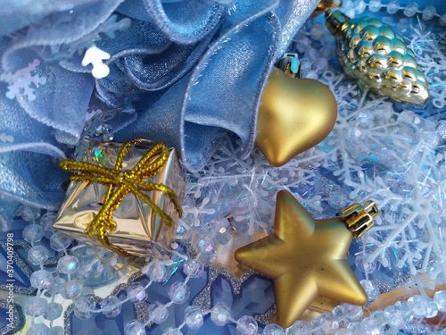 Beautiful blue background for a christmas card with gilged gold toys on the christmas tree photo