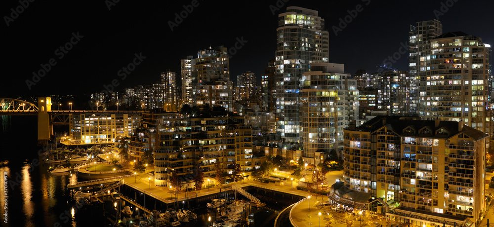 West End Vancouver Condominiums at night with False Creek Yacht Club and Burrard Street Bridge