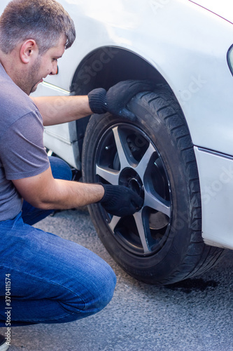 mechanic changing car wheel, car mechanic changing the wheel of a car © Gegham