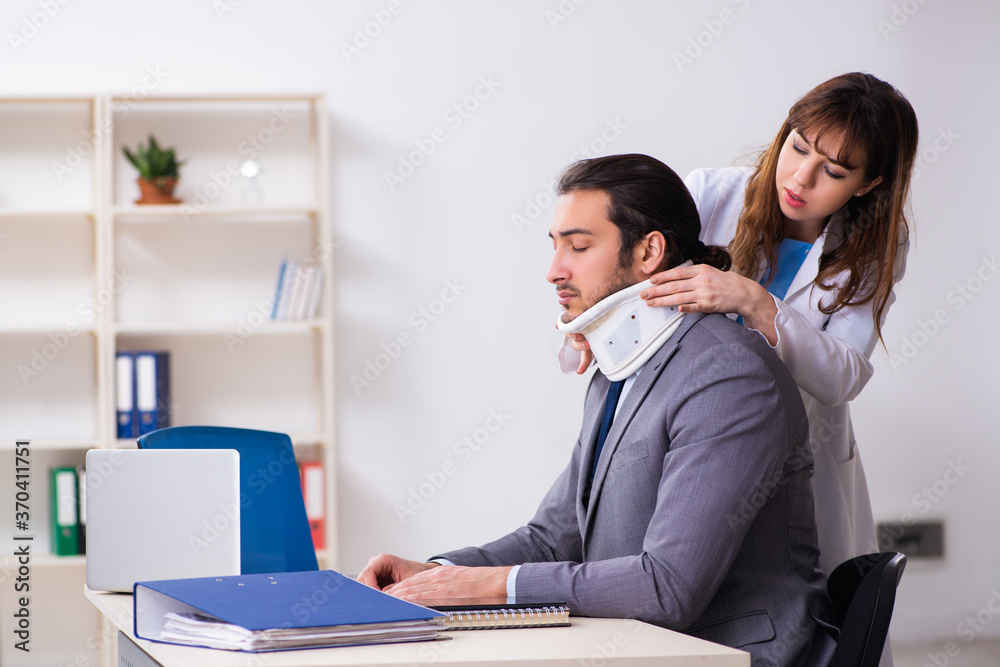 Young female doctor and sick businessman in the office Young female doctor and sick businessman in the office