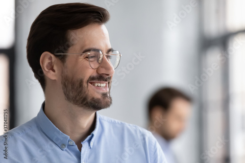 Close up profile smiling successful businessman wearing glasses looking to aside, business vision concept, overjoyed executive company owner dreaming, pondering project strategy or startup idea