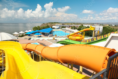 View from colorful slides in water park on sunny day