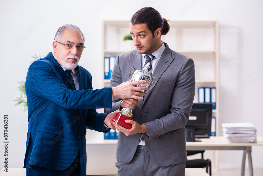 Two male employees working in the office Two male employees working in the office