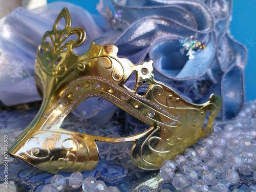 Fototapeta Naklejka Na Ścianę i Meble -  Gold carnival mask on a blue and gold christmas background