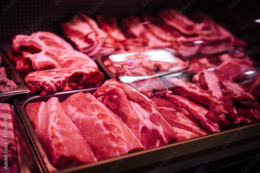 Obraz premium Butcher shop's meat window with meat packs. Different products in meat market. Meat counter.