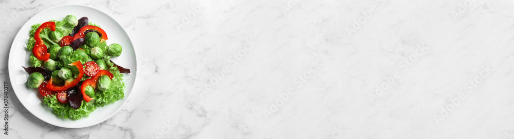 Tasty salad with Brussels sprouts and space for text on white marble table, top view. Banner design Tasty salad with Brussels sprouts and space for text on white marble table, top view. Banner design
