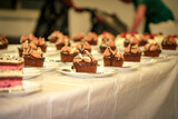 Table full of wedding deserts laid out for guests, sticky date pudding with caramel