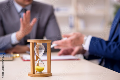 Two businessmen in time management concept