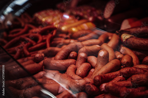A large number of sausages in the meat market. Variety of choice of meat products. Sausage sale.