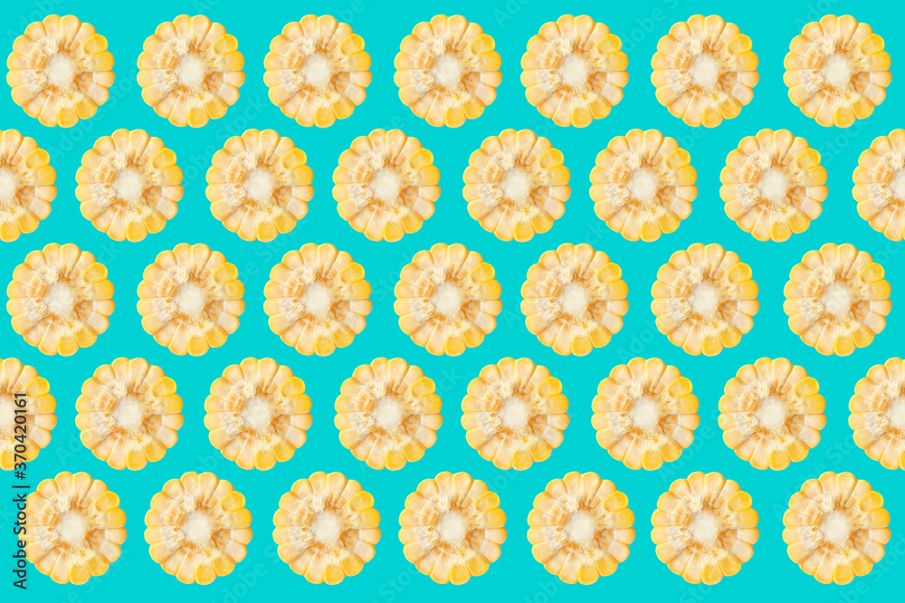 Pattern of corn cob pieces on turquoise background