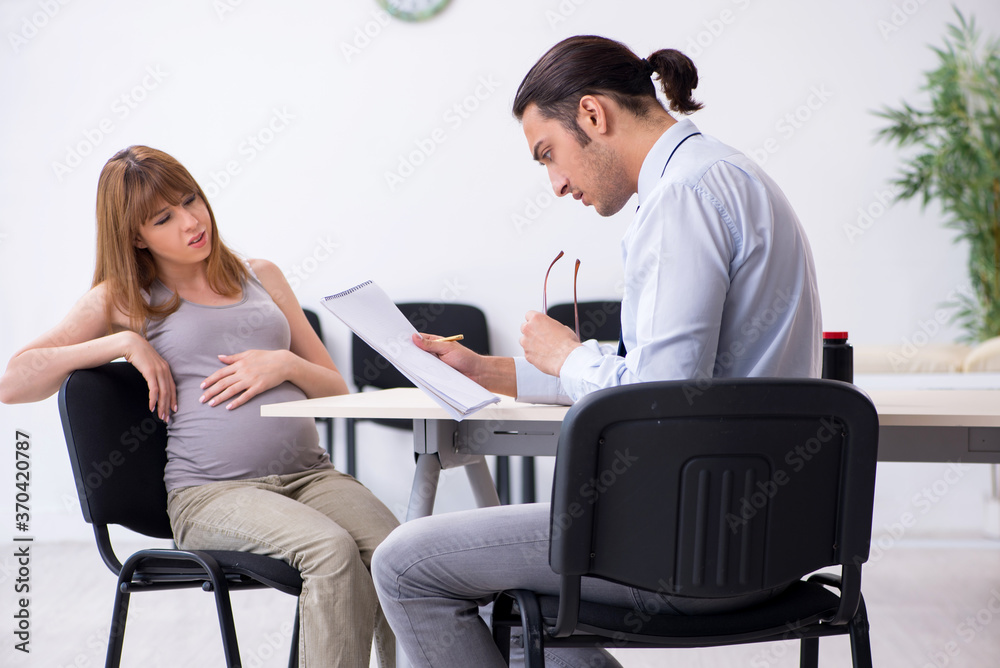 Pregnant woman visiting male psychologist doctor Pregnant woman visiting male psychologist doctor