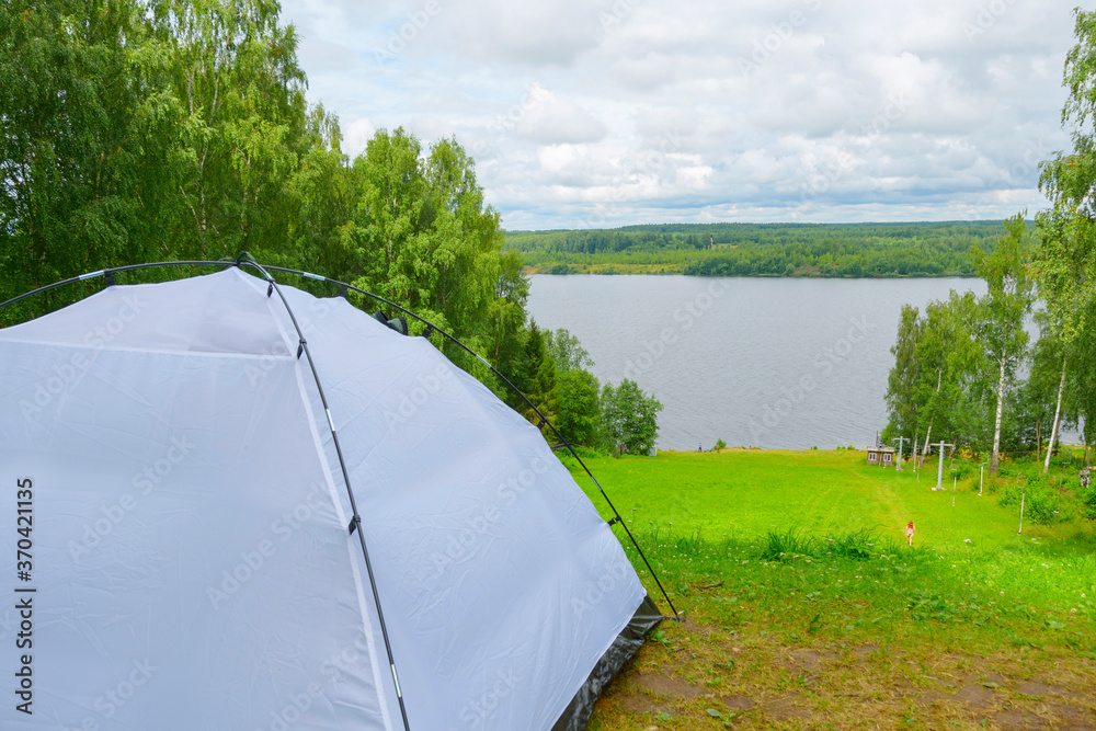 camping tent  on the river bank in a picturesque landscape