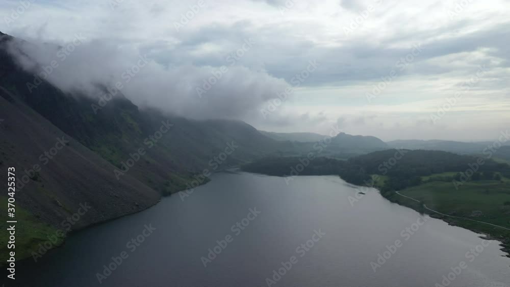 Aerial wide shot of a lake next to a mountain, in the English countryside. Aerial wide shot of a lake next to a mountain, in the English countryside.