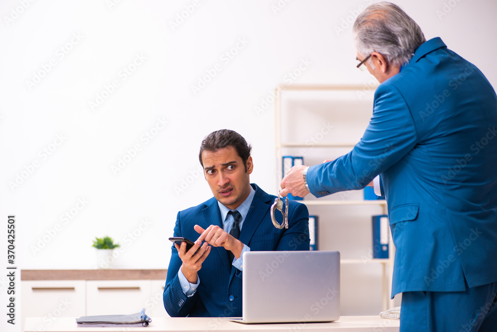 Male employee and cop in police investigation concept Male employee and cop in police investigation concept