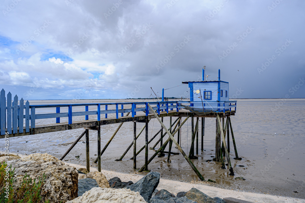 A fisherman's hut perched on wooden stakes. These huts are used for plaice fishing.