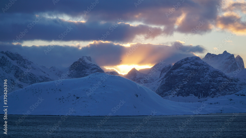 Cold snow winter landscapes with dominant Volandstind Peak during sunset at Fredvang, Lofoten, Norway.